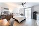 Serene bedroom with light wood floors, a ceiling fan, and large windows with sheer curtains at 7307 Grace Estate Ave, Las Vegas, NV 89113
