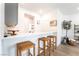 Bright kitchen bar area with wooden stools, white countertops, and decorative accents for a modern feel at 7307 Grace Estate Ave, Las Vegas, NV 89113