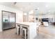 Open kitchen and living area with stainless steel refrigerator and a center island with bar stools at 7307 Grace Estate Ave, Las Vegas, NV 89113
