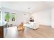 Bright living room featuring hardwood floors and white walls at 7307 Grace Estate Ave, Las Vegas, NV 89113