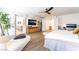 Bright main bedroom with light wood flooring and doorways that lead to a bathroom and closet at 7307 Grace Estate Ave, Las Vegas, NV 89113