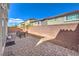 Spacious backyard with a charming brick-paved patio, gravel accents, and a privacy wall at 7732 Canon Walk St, Las Vegas, NV 89139
