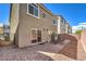 Spacious backyard with a brick-paved patio, gravel accents, and a secure metal gate at 7732 Canon Walk St, Las Vegas, NV 89139