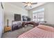 Cozy bedroom featuring carpet, large window, a guitar, and a corner desk with computer and speakers at 7732 Canon Walk St, Las Vegas, NV 89139