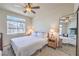 Bright bedroom with neutral tones, a large mirror, and a comfortable bed at 7732 Canon Walk St, Las Vegas, NV 89139