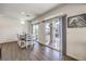 Bright dining room with a wood table and chairs and large sliding doors leading to the patio at 7732 Canon Walk St, Las Vegas, NV 89139