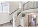 Bright entryway featuring a modern staircase with glass panels and an open view to the living area at 7732 Canon Walk St, Las Vegas, NV 89139