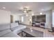 Comfortable living room featuring a large TV, sectional sofa, and ample natural light at 7732 Canon Walk St, Las Vegas, NV 89139