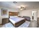 Serene main bedroom with wood accents, soft lighting, and a cozy seating area at 7732 Canon Walk St, Las Vegas, NV 89139