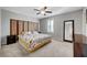 Bedroom featuring carpet, ceiling fan, and a queen bed with patterned bedding and decorative headboard at 7870 Formitch Ct, Las Vegas, NV 89166