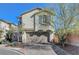 Two-story home showcasing detailed garage doors, desert landscaping and clean architectural lines at 7870 Formitch Ct, Las Vegas, NV 89166