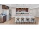 Modern kitchen with a granite island, stainless steel appliances, and dark wood cabinetry at 7870 Formitch Ct, Las Vegas, NV 89166