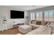 Inviting living room with a plush sectional sofa, plantation shutters, and modern decor at 7870 Formitch Ct, Las Vegas, NV 89166