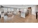 Open-concept living room featuring wood floors, large windows, and seamless flow to the kitchen at 7870 Formitch Ct, Las Vegas, NV 89166