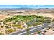 Aerial view of a neighborhood park featuring playground, picnic area, parking lot, and mature trees near desert community at 7941 Limestone Arch Ave, Las Vegas, NV 89178