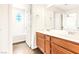 Bathroom features double sinks, wood cabinets and a tub-shower combo with tiled walls at 7941 Limestone Arch Ave, Las Vegas, NV 89178
