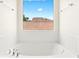 Relaxing bathtub with a view, tile surround, and natural light at 7941 Limestone Arch Ave, Las Vegas, NV 89178