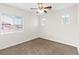 Bedroom featuring neutral carpet, white walls, ceiling fan, and bright, natural light at 7941 Limestone Arch Ave, Las Vegas, NV 89178