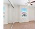 Bright bedroom with mirrored closet doors, a ceiling fan, and ample natural light at 7941 Limestone Arch Ave, Las Vegas, NV 89178