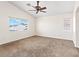 Bright bedroom featuring a ceiling fan, carpeted floor, and two windows at 7941 Limestone Arch Ave, Las Vegas, NV 89178