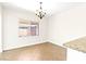 Bright dining area with a window, chandelier and tiled flooring at 7941 Limestone Arch Ave, Las Vegas, NV 89178