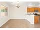 Dining room with window, chandelier, and breakfast bar into the kitchen at 7941 Limestone Arch Ave, Las Vegas, NV 89178