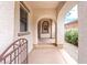 Inviting front porch with arched entryway and serene water feature at 7941 Limestone Arch Ave, Las Vegas, NV 89178