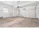 Spacious two car garage with concrete flooring, lighting, and roll up door at 7941 Limestone Arch Ave, Las Vegas, NV 89178