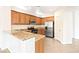 Well-lit kitchen boasts wood cabinets, stainless steel appliances, and granite countertops at 7941 Limestone Arch Ave, Las Vegas, NV 89178