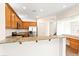 Modern kitchen with stainless steel appliances, wooden cabinets, granite countertops and bar seating at 7941 Limestone Arch Ave, Las Vegas, NV 89178