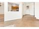 Open-concept living room with tile flooring and a glimpse of the kitchen through a cutout at 7941 Limestone Arch Ave, Las Vegas, NV 89178