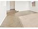 Open floor plan featuring tile and carpet flooring, with steps leading to another space at 7941 Limestone Arch Ave, Las Vegas, NV 89178