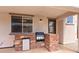 Covered patio featuring an outdoor kitchen area with a stone counter, grill, and mini-fridge at 7941 Limestone Arch Ave, Las Vegas, NV 89178