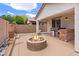 Covered patio featuring a built-in grill, fire pit, and desert landscaping at 7941 Limestone Arch Ave, Las Vegas, NV 89178