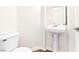 Clean half bathroom with a pedestal sink and a white toilet at 7941 Limestone Arch Ave, Las Vegas, NV 89178