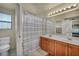 Bright bathroom featuring double sinks, and a shower-tub combination at 8421 Cheerful Brook Ave, Las Vegas, NV 89143