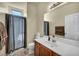 Well-lit bathroom features a white vanity, framed mirror, and a shower with a curtain at 8421 Cheerful Brook Ave, Las Vegas, NV 89143