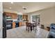 Bright kitchen features oak cabinets, black appliances, and a dining table with backyard access at 8421 Cheerful Brook Ave, Las Vegas, NV 89143