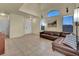 Inviting living room with high ceilings, natural light, and a brown leather sectional sofa at 8421 Cheerful Brook Ave, Las Vegas, NV 89143