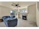Cozy living room with a marble fireplace, ceiling fan, and a comfortable blue sectional sofa at 8421 Cheerful Brook Ave, Las Vegas, NV 89143