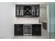 Elegant bar area featuring custom cabinetry, wine rack, and built-in wine refrigerator at 91 Alta Cascata Pl, Henderson, NV 89011