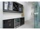 Modern bar area with sleek cabinetry, wine storage, and beverage cooler at 91 Alta Cascata Pl, Henderson, NV 89011