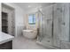 Bright primary bathroom with a tub and glass-enclosed shower at 91 Alta Cascata Pl, Henderson, NV 89011