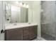 Bathroom featuring double vanity, quartz countertop, framed mirrors, and glass walk-in shower at 91 Alta Cascata Pl, Henderson, NV 89011