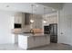 Bright kitchen features stainless steel appliances, a central island, and modern pendant lighting fixtures at 91 Alta Cascata Pl, Henderson, NV 89011