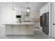 Modern kitchen with stainless steel appliances, white cabinets, and a central island with granite countertops at 91 Alta Cascata Pl, Henderson, NV 89011