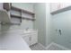 Well-organized laundry room featuring extra counter space, storage cabinets and designer tile flooring at 91 Alta Cascata Pl, Henderson, NV 89011