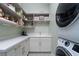 Laundry room with built in storage, countertops, and laundry machines at 91 Alta Cascata Pl, Henderson, NV 89011