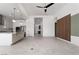 Open-concept living space with granite kitchen island, stainless appliances, and wood accent wall at 91 Alta Cascata Pl, Henderson, NV 89011