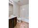 Tiled bathroom featuring a tub, shower, and vanity, complemented by neutral walls and updated fixtures at 9530 Redstar St, Las Vegas, NV 89123